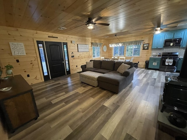 137 Maplewood Dr, Naples, ME 04055 - living area with ceiling fan, wood ceiling, wooden walls, and wood finished floors