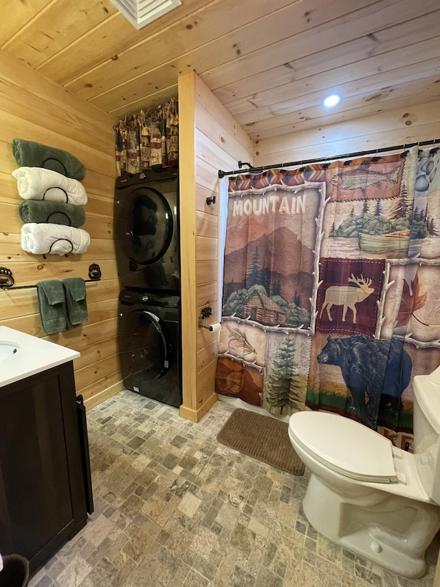 137 Maplewood Dr, Naples, ME 04055 - full bath with estacked washer and dryer, wooden walls, brick patterned floors, toilet, and wood ceiling