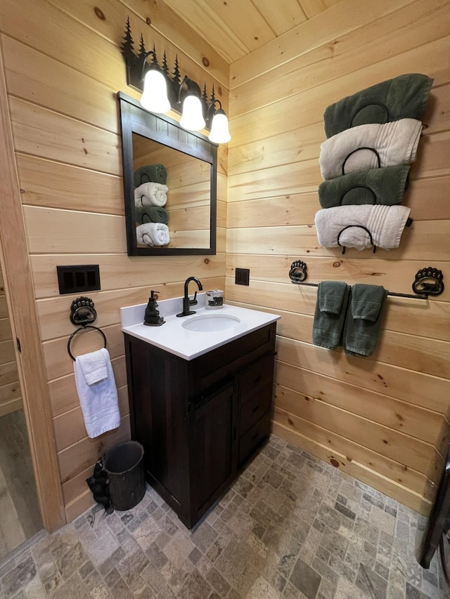 137 Maplewood Dr, Naples, ME 04055 - bathroom with wooden walls, vanity, and brick patterned flooring