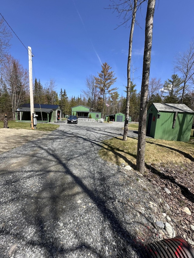 view of street with gravel driveway