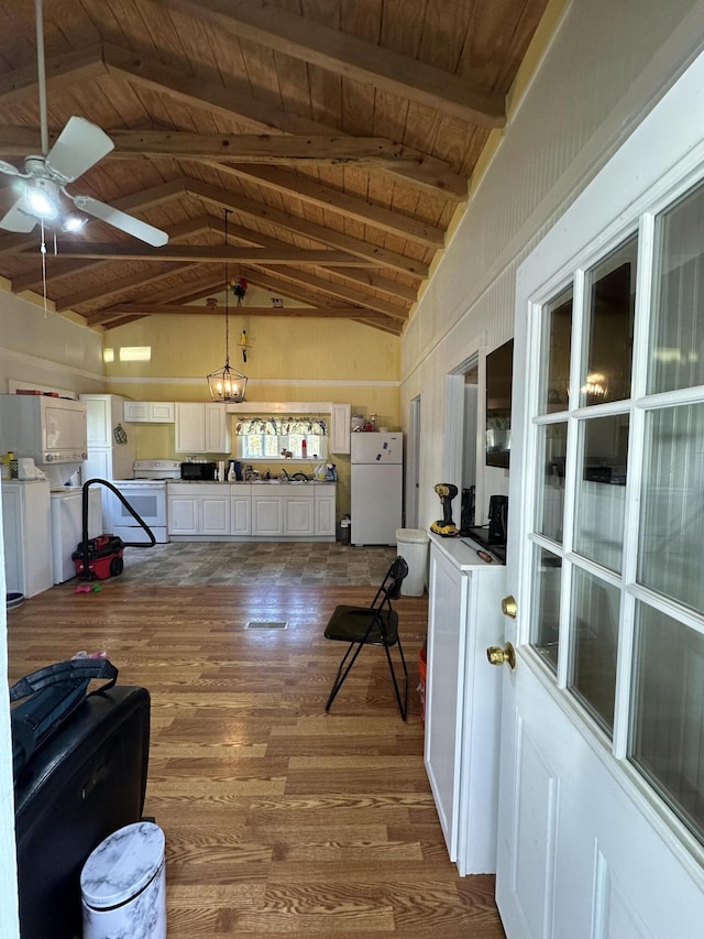 interior space with ceiling fan, lofted ceiling with beams, wood ceiling, and dark wood finished floors