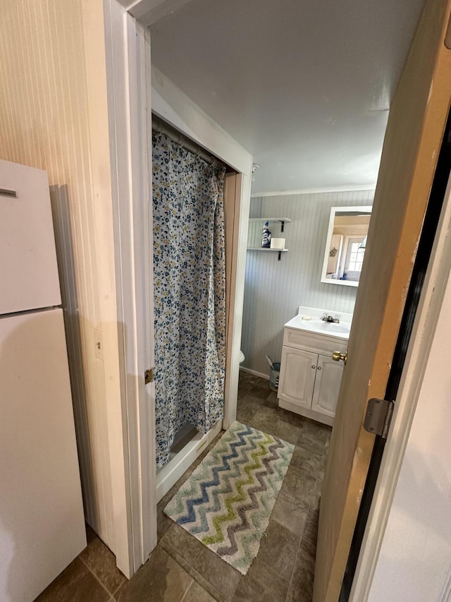 bathroom featuring vanity, a shower stall, and toilet