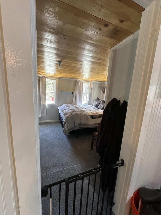 bedroom featuring carpet flooring and wooden ceiling
