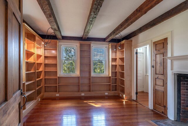 258 River Rd, Eliot, ME 03903 - interior space featuring beamed ceiling, a brick fireplace, and hardwood / wood-style flooring