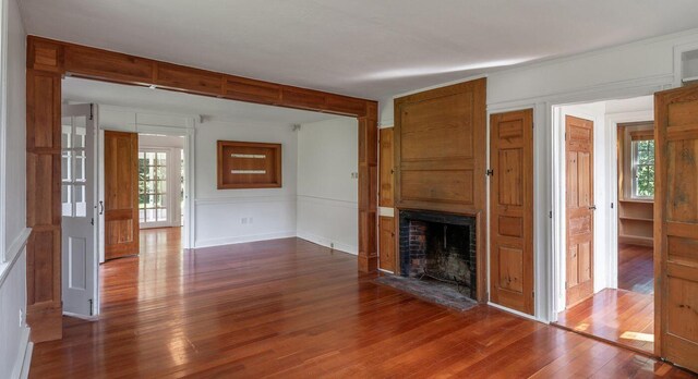 258 River Rd, Eliot, ME 03903 - unfurnished living room with baseboards, dark wood finished floors, and a fireplace