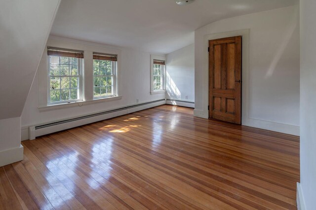 258 River Rd, Eliot, ME 03903 - interior space featuring a baseboard radiator, wood finished floors, and vaulted ceiling