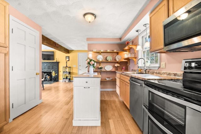 31 Saltwater Dr, York, ME 03909 - kitchen with stainless steel appliances, a sink, open shelves, a fireplace with flush hearth, and baseboards