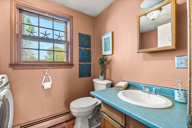 31 Saltwater Dr, York, ME 03909 - half bathroom with baseboard heating, washer / dryer, toilet, vanity, and tile patterned flooring