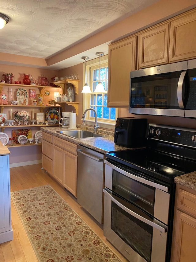 31 Saltwater Dr, York, ME 03909 - kitchen with appliances with stainless steel finishes, a sink, light wood-type flooring, and decorative light fixtures