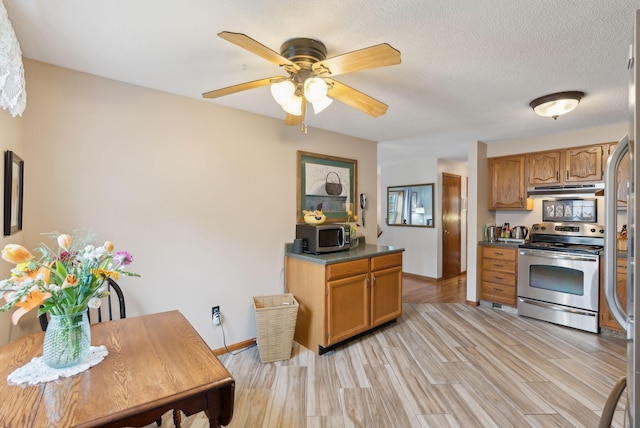 171 Regan Ln, Portland, ME 04103 - kitchen with appliances with stainless steel finishes, under cabinet range hood, light wood-style flooring, ceiling fan, and brown cabinets