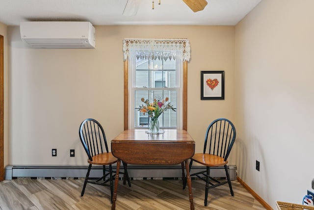 171 Regan Ln, Portland, ME 04103 - dining room featuring a wall mounted air conditioner, light wood-style flooring, ceiling fan, and a baseboard radiator