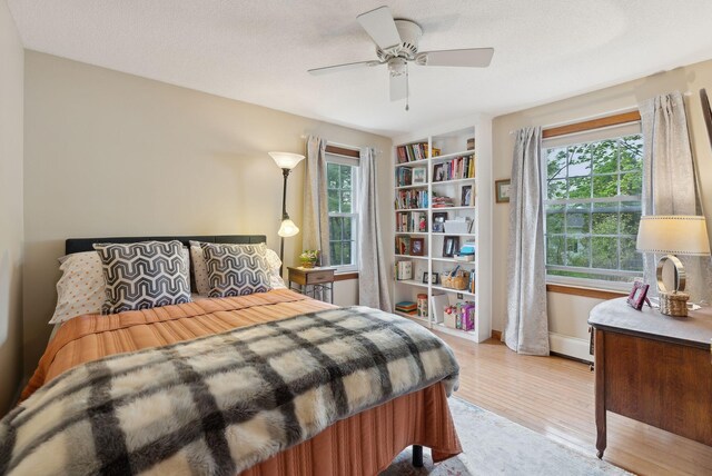 171 Regan Ln, Portland, ME 04103 - bedroom featuring multiple windows, wood finished floors, ceiling fan, and baseboards