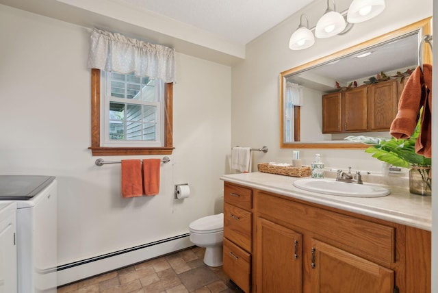 171 Regan Ln, Portland, ME 04103 - bathroom featuring baseboard heating, washing machine and dryer, stone finish floors, toilet, and vanity