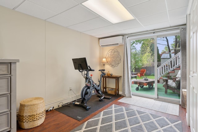 171 Regan Ln, Portland, ME 04103 - exercise area featuring a wall mounted air conditioner, a drop ceiling, and wood finished floors