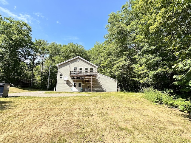 1057 Back Brooks Rd, Monroe, ME 04951 - rear view of house with a yard, stairway, and a wooden deck