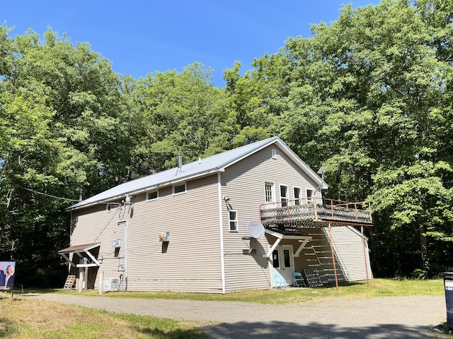 1057 Back Brooks Rd, Monroe, ME 04951 - exterior space with metal roof, a wooded view, and a deck