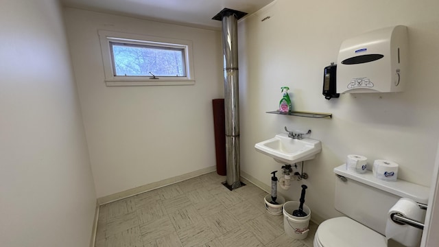 1057 Back Brooks Rd, Monroe, ME 04951 - bathroom featuring toilet, baseboards, and a sink