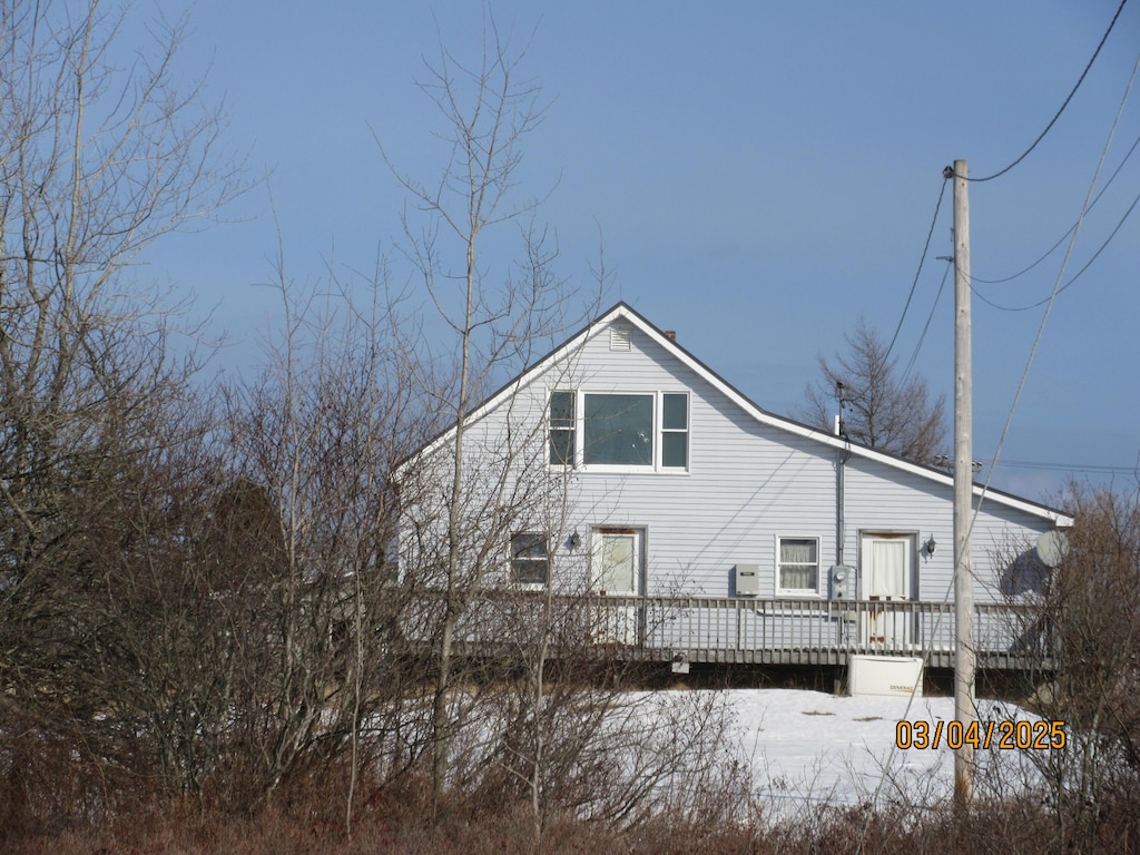 rear view of property featuring a deck