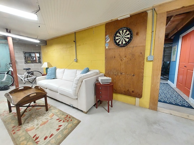 372 Pine Springs Rd, Shapleigh, ME 04076 - living area featuring concrete block wall and concrete flooring