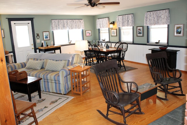 372 Pine Springs Rd, Shapleigh, ME 04076 - living area featuring ceiling fan, light wood-style floors, and a wainscoted wall