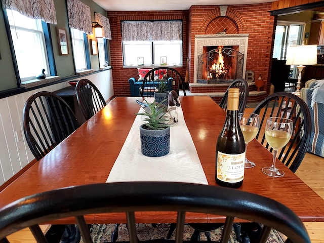 372 Pine Springs Rd, Shapleigh, ME 04076 - dining room featuring brick wall and a brick fireplace