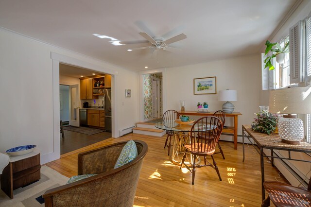 dining area with ceiling fan, baseboard heating, recessed lighting, light wood-type flooring, and ornamental molding