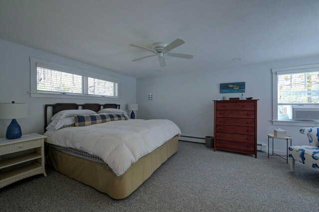 bedroom featuring a ceiling fan, light colored carpet, multiple windows, and baseboard heating