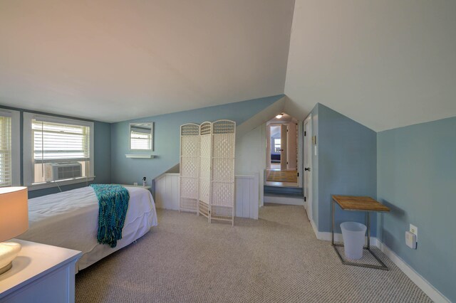bedroom with baseboards, light carpet, lofted ceiling, and cooling unit