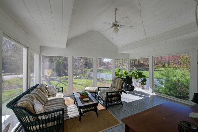 sunroom / solarium with ceiling fan and an outdoor living space