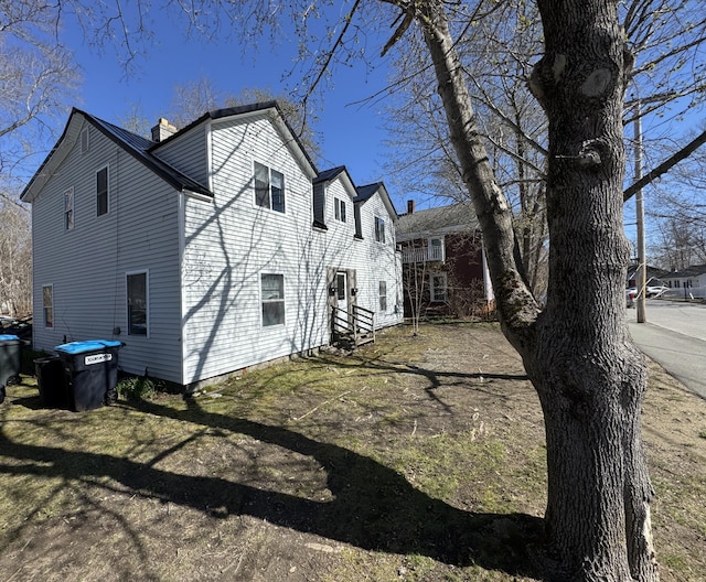 view of property exterior with a chimney