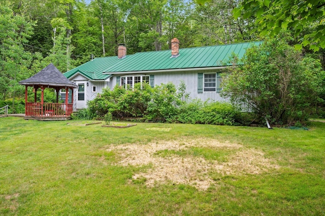 95 Hatcase Pond Rd, Eddington, ME 04428 - rear view of property featuring a gazebo, a chimney, a standing seam roof, a yard, and a metal roof