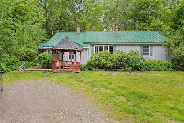 95 Hatcase Pond Rd, Eddington, ME 04428 - view of front of house featuring a chimney, a gazebo, a front lawn, and a metal roof