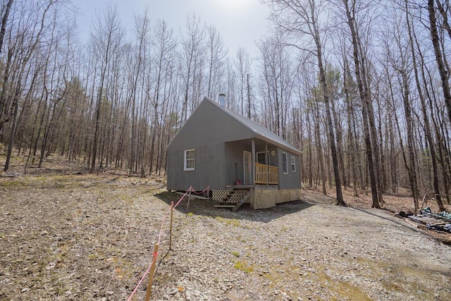 view of outbuilding featuring a view of trees