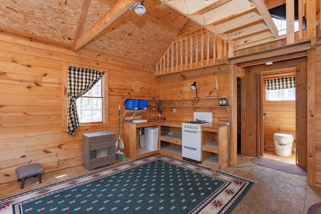 unfurnished bedroom featuring heating unit, high vaulted ceiling, and wood walls