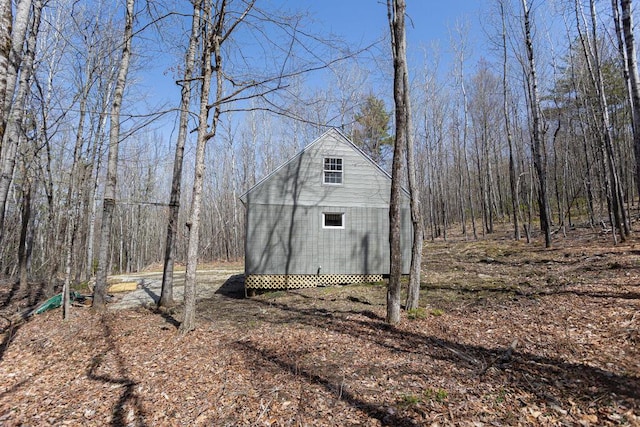 view of shed featuring a forest view