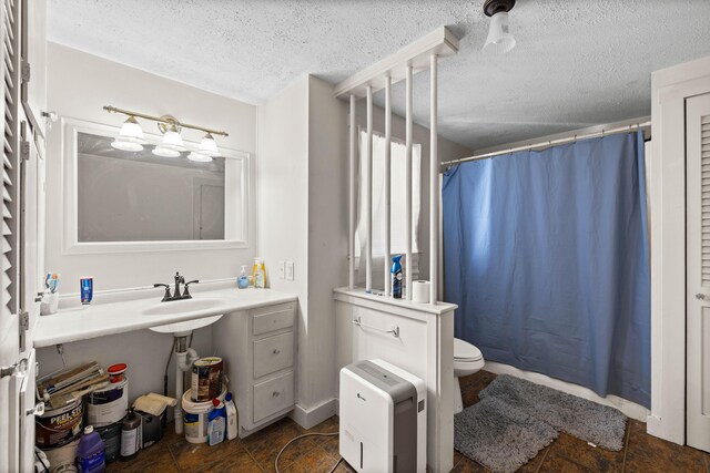 1654 Carl Broggi Hwy, Lebanon, ME 04027 - bathroom featuring toilet, a textured ceiling, a sink, and a shower with shower curtain