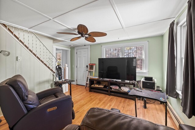 1654 Carl Broggi Hwy, Lebanon, ME 04027 - living room featuring ceiling fan, a baseboard heating unit, wood finished floors, and stairway