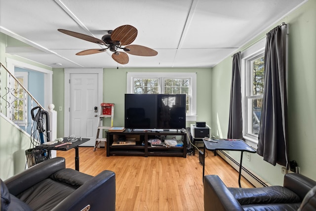 1654 Carl Broggi Hwy, Lebanon, ME 04027 - living area with ceiling fan, baseboard heating, stairs, and light wood-style flooring