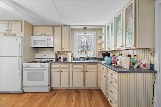 1654 Carl Broggi Hwy, Lebanon, ME 04027 - kitchen with light wood-style floors, dark countertops, cream cabinetry, and white appliances