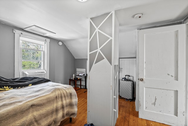 1654 Carl Broggi Hwy, Lebanon, ME 04027 - bedroom with wood-type flooring, lofted ceiling, and cooling unit