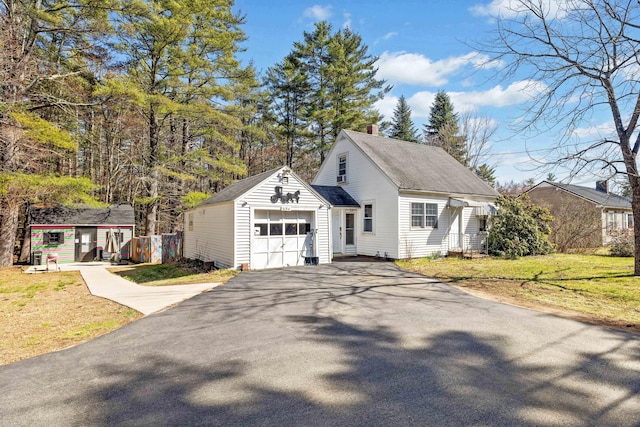 1654 Carl Broggi Hwy, Lebanon, ME 04027 - exterior space featuring driveway, a chimney, a lawn, a garage, and an outdoor structure