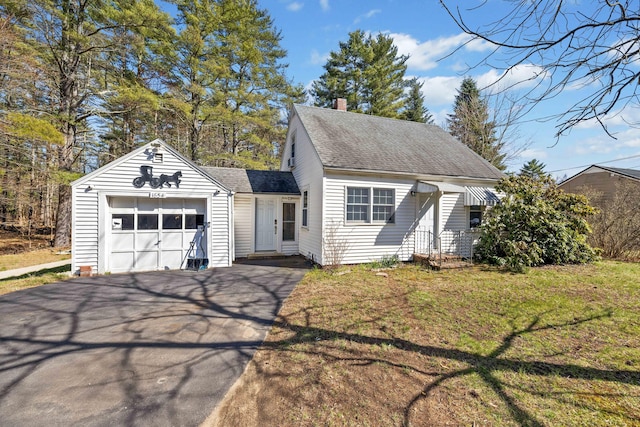 1654 Carl Broggi Hwy, Lebanon, ME 04027 - view of front of house with a garage, a front yard, roof with shingles, a chimney, and driveway