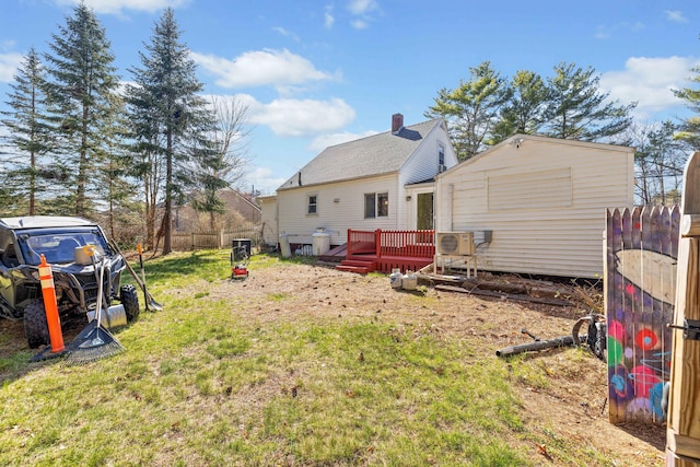 1654 Carl Broggi Hwy, Lebanon, ME 04027 - rear view of house featuring fence, ac unit, a wooden deck, an outbuilding, and a yard