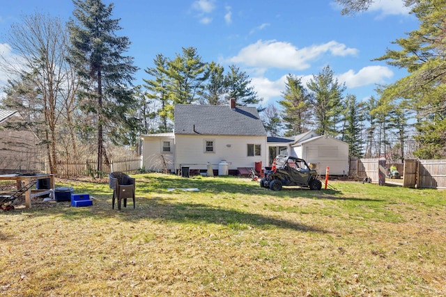 1654 Carl Broggi Hwy, Lebanon, ME 04027 - rear view of property featuring a lawn, fence, and a chimney