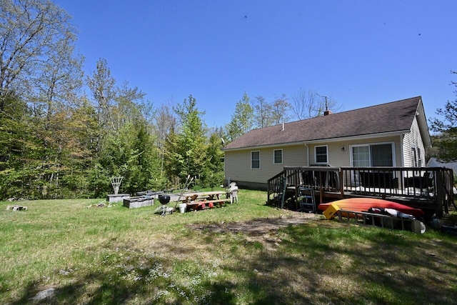47 Taylor Ln, Naples, ME 04055 - rear view of house featuring a deck, a chimney, and a lawn