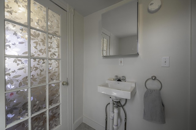 bathroom with baseboards and a sink