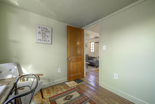 home office featuring wood-type flooring and baseboards