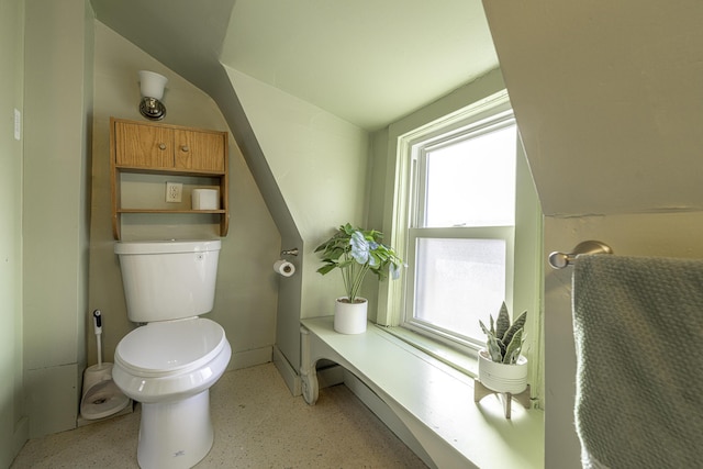 bathroom with lofted ceiling and toilet
