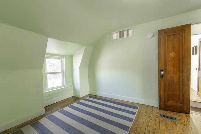 bonus room featuring visible vents, wood finished floors, and lofted ceiling