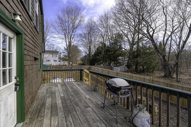wooden deck featuring a fenced backyard